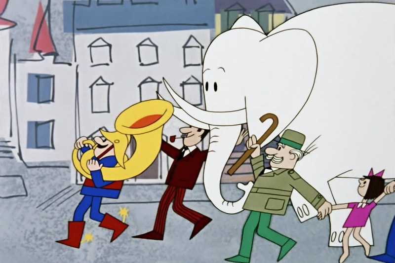 Parada w formie kreskówki z chłopcem grającym na tubie, białym słoniem, mężczyzną w garniturze, mężczyzną w zielonym mundurze z laską i dziewczynką w różowej sukience idącą ulicą miasta.