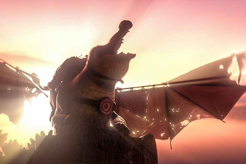 Krokodyl o dużych, poszarpanych skrzydłach i tarczą na piersi stoi na kamiennej wieży i ryczy na tle rozświetlonego, zachodzącego słońca.