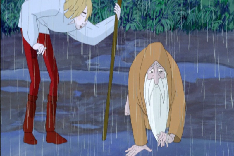 Animowana scena przedstawiająca młodą osobę o blond włosach i czerwonych spodniach pochylającą się nad starszą, brodatą postacią w brązowym płaszczu, idącą na czworakach w deszczu.