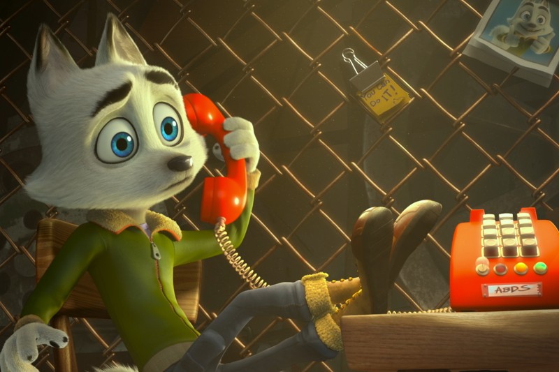 Animowany wilk ubrany w zieloną koszulę i kapcie siedzi na krześle, rozmawiając przez czerwony telefon z tarczą. Zdjęcie innego wilka i kłódki wisi na płocie w tle. Scena jest ciepło oświetlona.