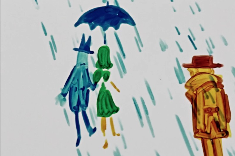 Kolorowy rysunek dwóch postaci pod parasolem w deszczu, jedna w niebieskim, a druga w zielonym, trzymających się za ręce. Trzecia postać w żółtym i brązowym kapeluszu i płaszczu stoi osobno, również w deszczu.