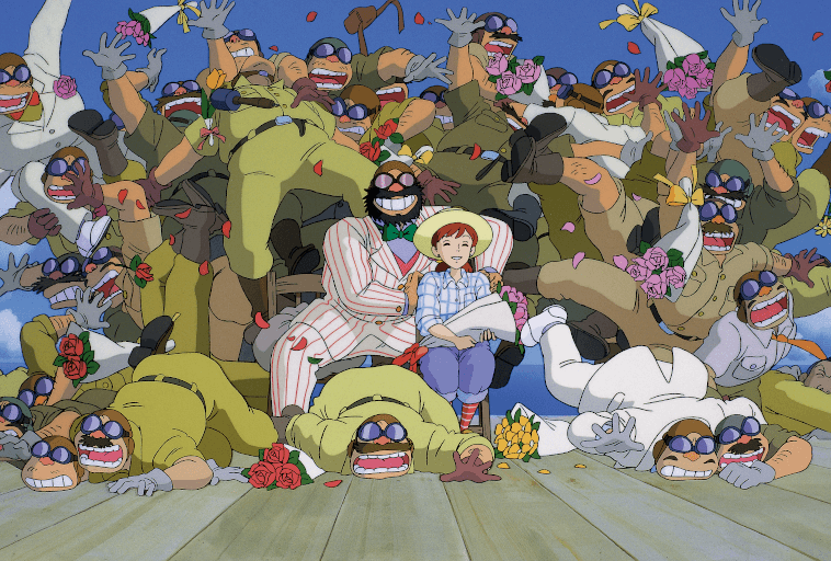 Animowana scena przedstawia młodego chłopca i mężczyznę w pasiastym garniturze, którzy spokojnie siedzą pośród chaotycznego tłumu uśmiechniętych, wąsatych mężczyzn w różnych mundurach, rzucających kwiaty i noszących okulary przeciwsłoneczne.