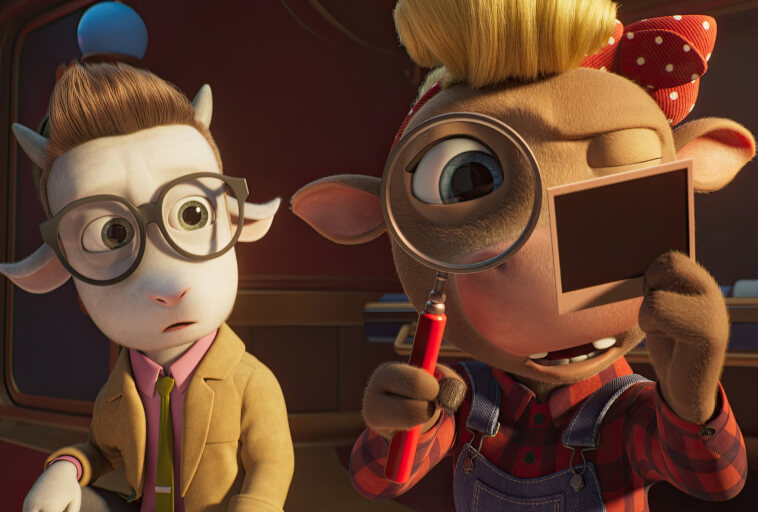 Dwie animowane postacie kóz: jedna w okularach i garniturze, wygląda na zaskoczoną, druga zaś, ubrana w ogrodniczki i czerwoną kraciastą koszulę, przygląda się zdjęciu przez lupę, mrużąc jedno oko.